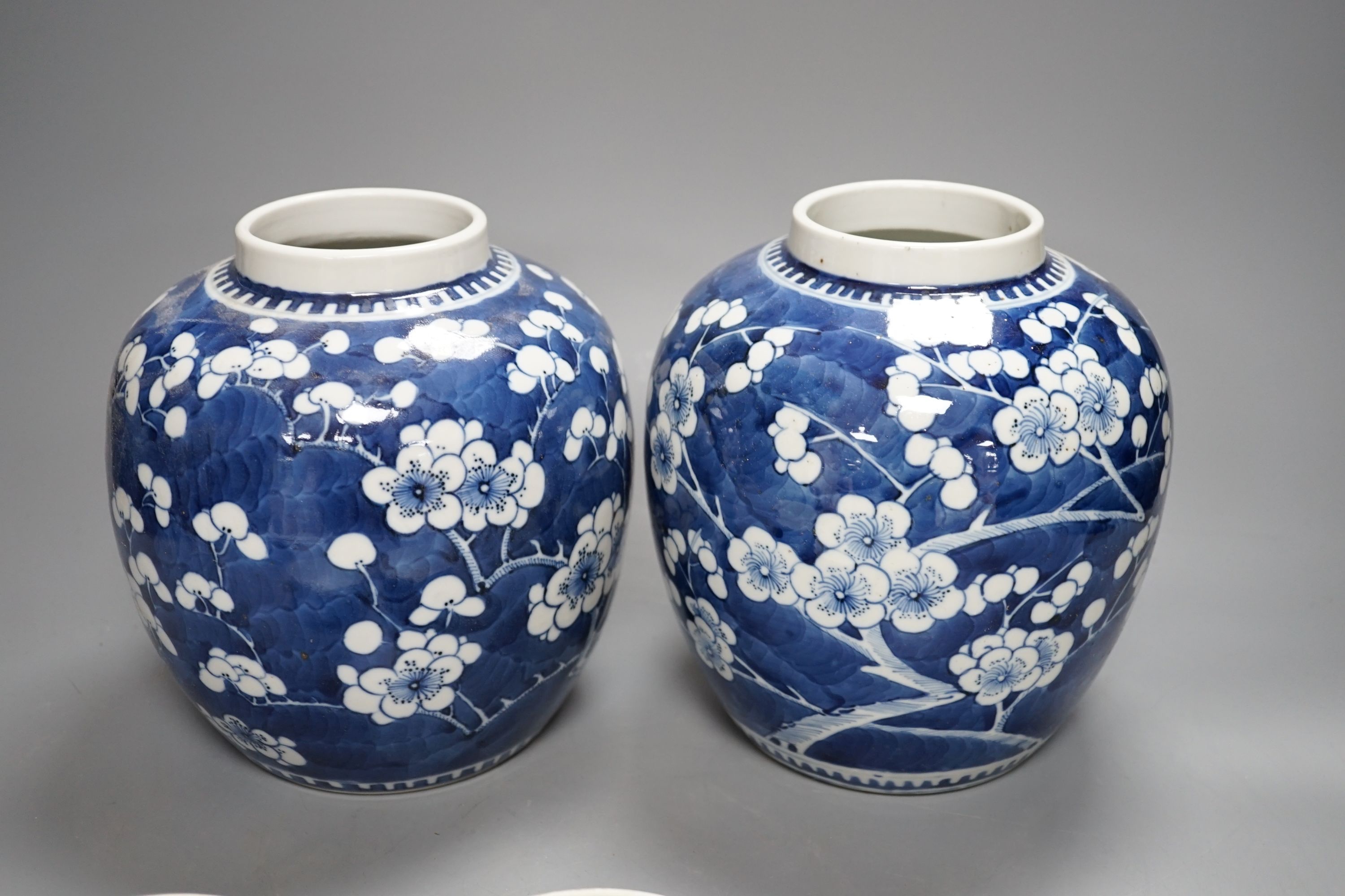 A pair of Chinese blue and white ginger jars and covers, 22 cms high including cover.